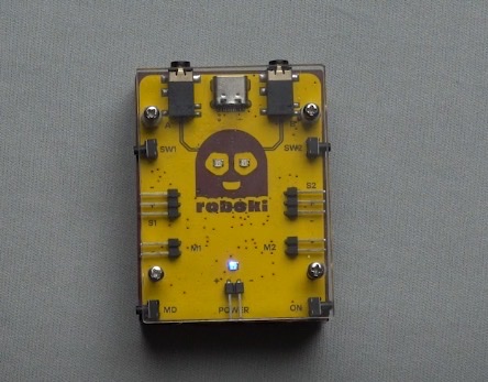 Roboki, the versatile microcontroller developed by Yudu Robotics, positioned on a surface with a grey background.