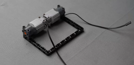 Another motor connected to the block, illustrating the setup for the pet robot project, ideal for tech enthusiasts interested in robotic and electronics projects.