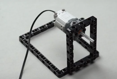 a technic axle is taken and fixed onto the technic DC motor. This is where the spin wheel is going to be attached.