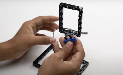 Take a Beam 5 and attach two friction pegs to the second and fourth holes of the beam, connecting it to the pin connector for this engaging robotics project.