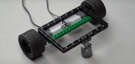 Carefully attaching beam 15 to the underside of the block emphasizes the intricacies of structural design in robotic projects, crucial for creating stable autonomous bots.